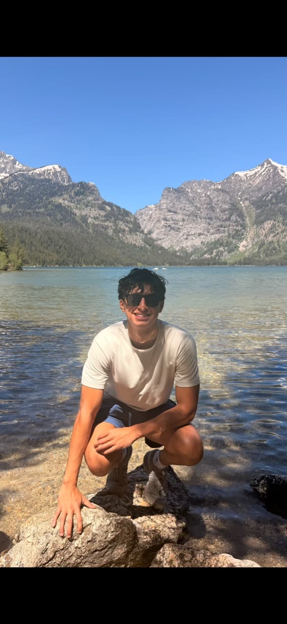 Carlos Castro outdoors by a mountain lake
